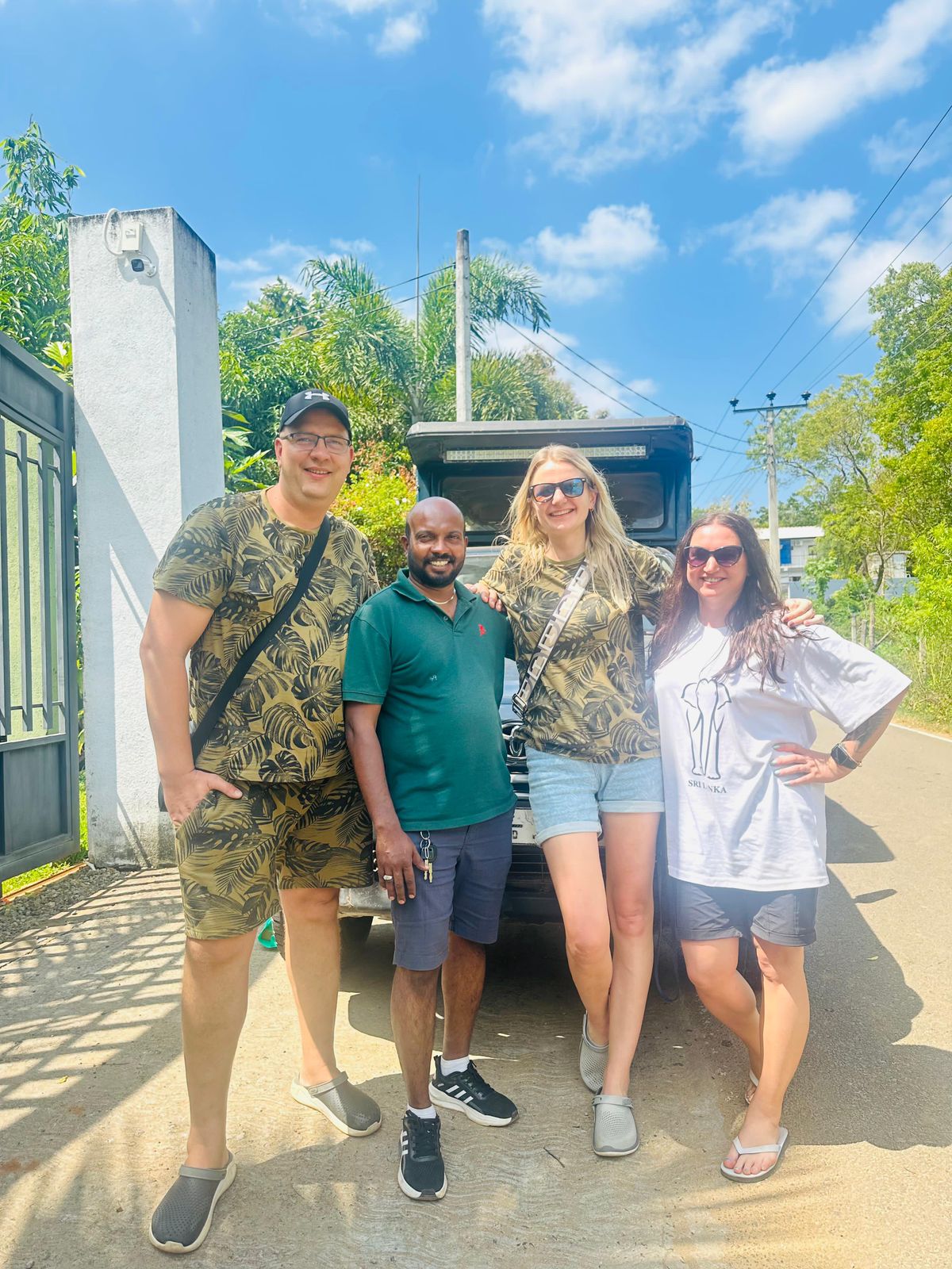 Travellers posing together outside a building