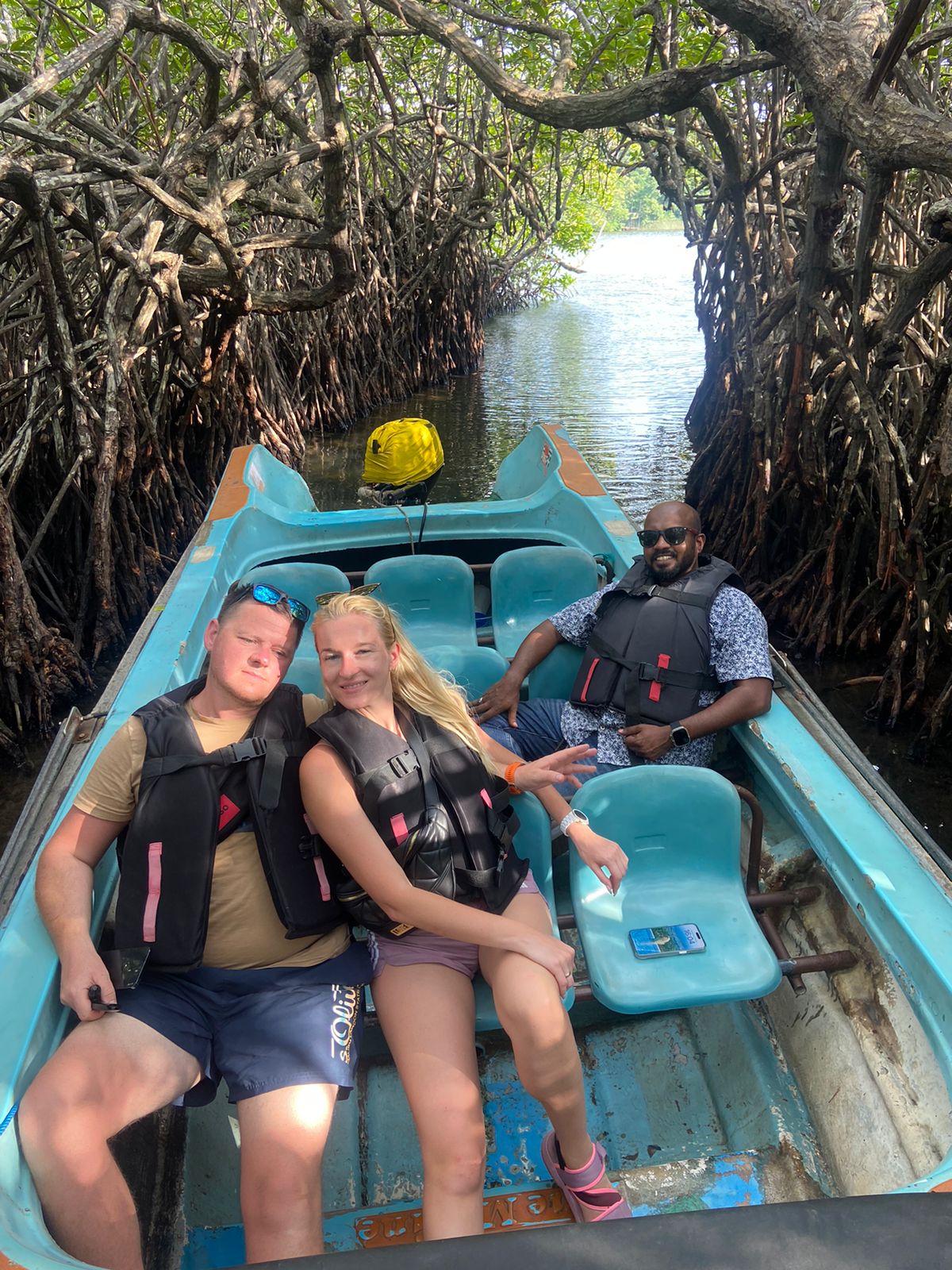 A couple enjoying a boat ride through mangroves