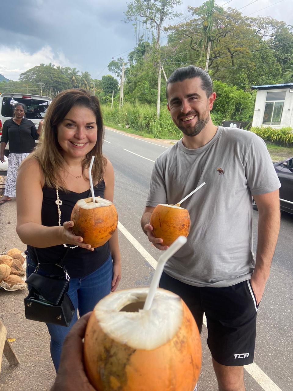 Visitors enjoying fresh coconut drinks