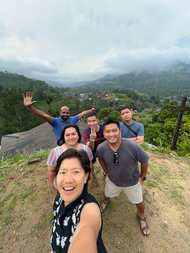 A group selfie at a mountain viewpoint