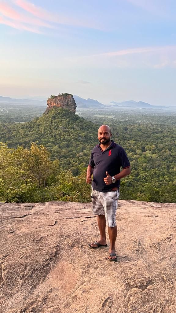 A traveller on a rocky lookout facing Sigiriya