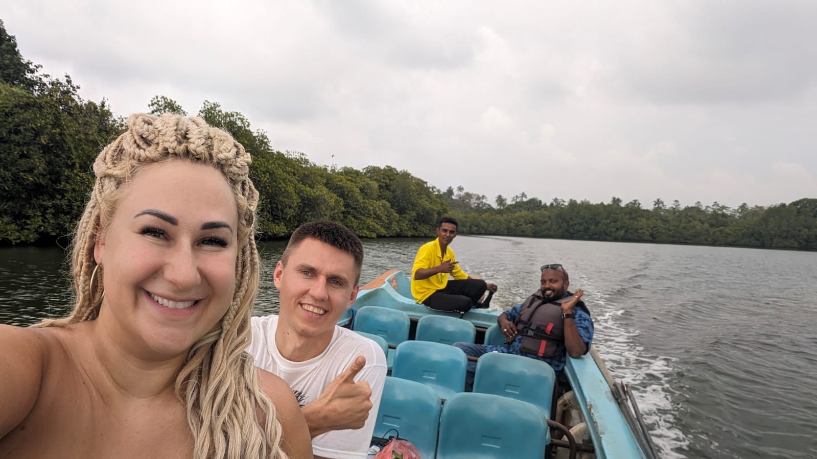 A group enjoying a boat ride across a lake