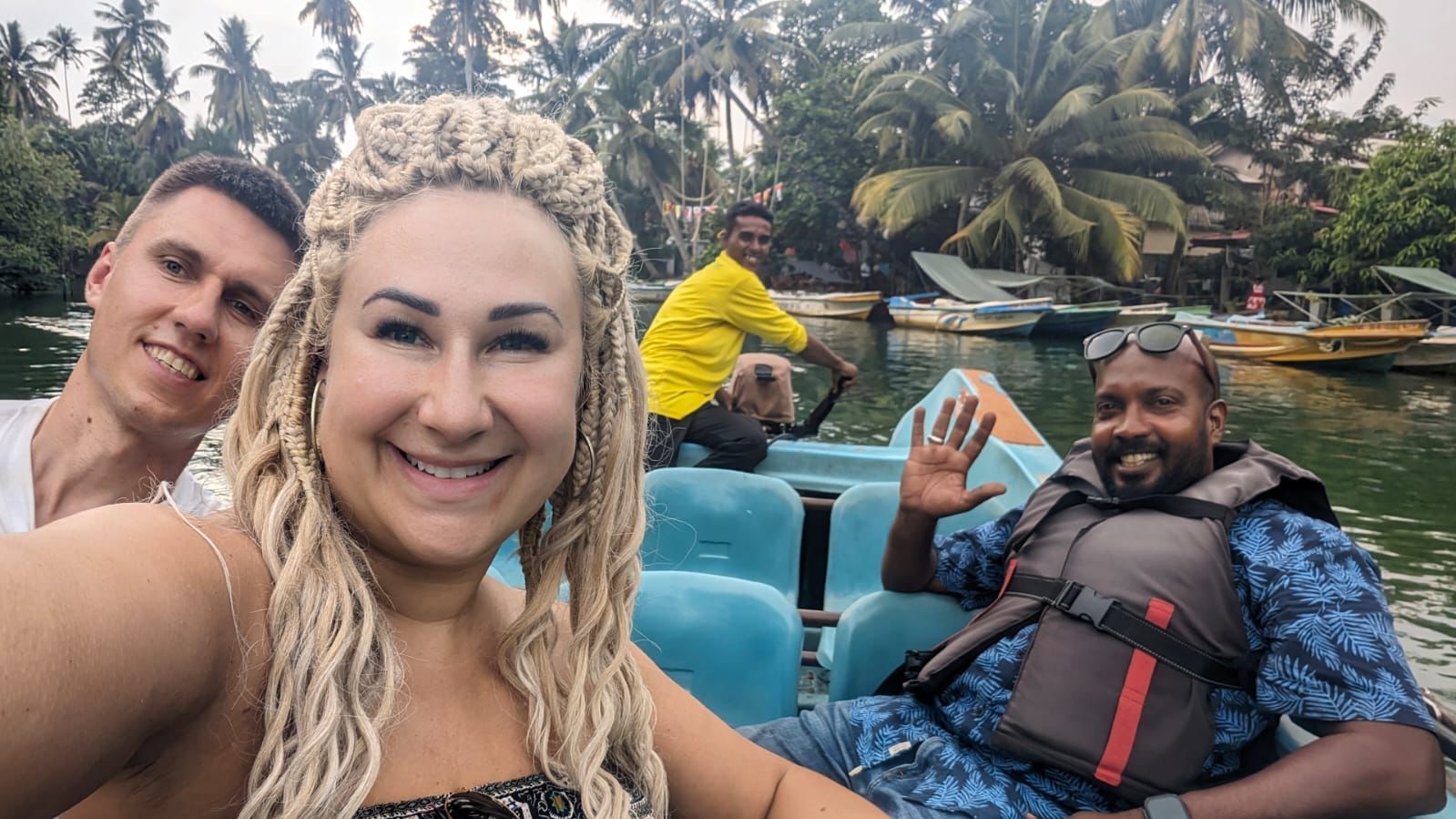 Travellers taking a selfie on a boat near the shore