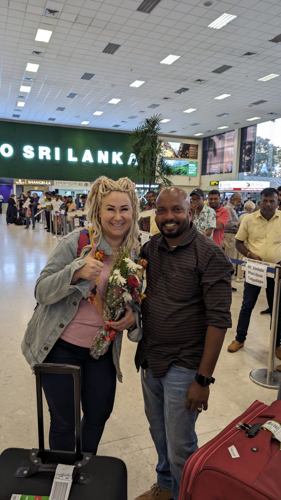 Travellers posing at an airport arrival area