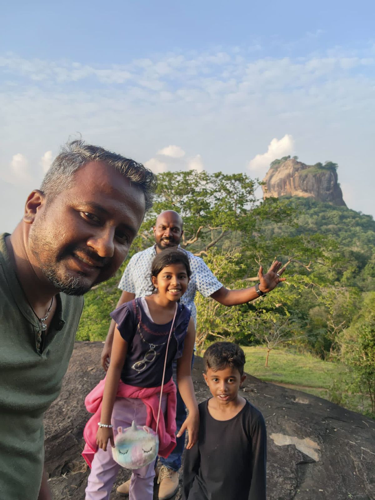 Travellers taking a selfie with Sigiriya in the background