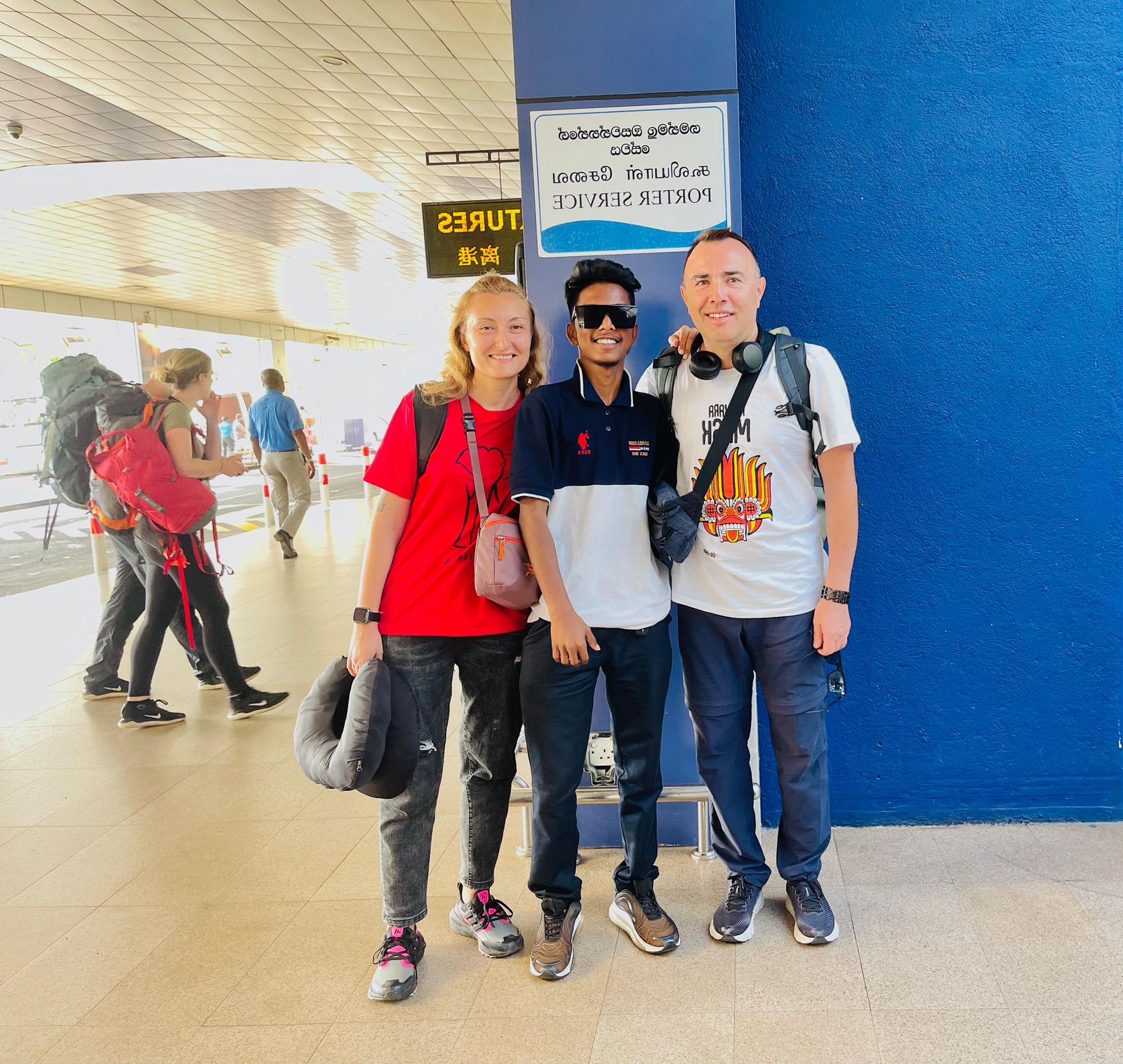 Travellers posing together with their luggage